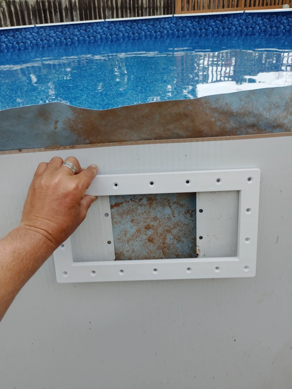 Skimmer opening being repaired on an above-ground pool wall